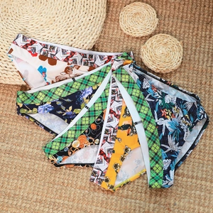Flat lay of multiple printed men's cotton briefs with diverse patterns on a straw mat
