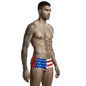 Detailed view of men's athletic swimming trunks with American flag pattern and red waistband