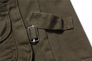 Detailed view of olive green twill cotton fabric with metal buckle and reinforced stitching