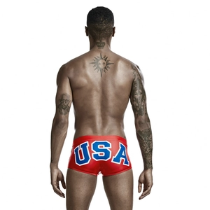 Rear view of red men's swim trunks with large blue and white USA print and elastic waist