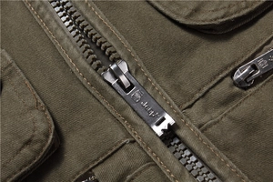 Detailed macro view of the heavy-duty metal zipper on this army green utility vest