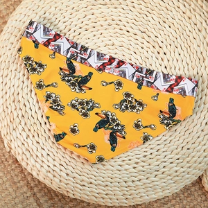 Flat lay of yellow cotton briefs with toucan prints and playing card waist pattern