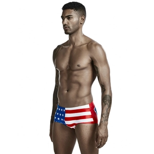 Detailed side view of men's square-cut swimming trunks with American flag pattern