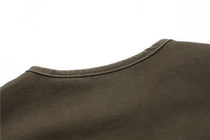 Detail view of smooth olive green crew neck stitching on durable twill cotton men vest