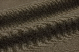 Macro shot of durable olive green twill fabric texture for men's padded vest