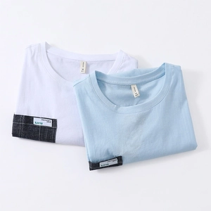 Folded men's loose crew neck short sleeve T-shirts in white and light blue cotton