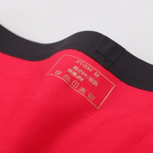 Close-up of red cotton modal boxer briefs with black elastic waistband and size label