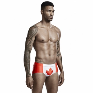 Detail of men's low-waist swimming trunks with a red Canada maple leaf flag print