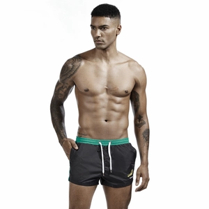 Detail of men's athletic shorts with elastic green waistband and white drawstring