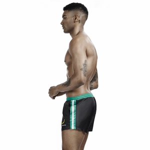 Detail of men's black sports shorts with green waistband and banana print graphic