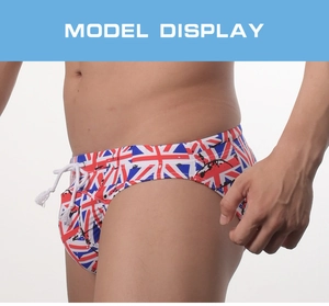 Close-up of men's swim briefs featuring a UK flag pattern and white drawstring detail