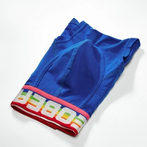 Detail view of men's blue boxer briefs featuring a rainbow striped elastic waistband