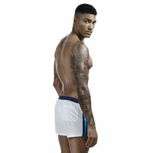 Detail view of white men's swim shorts with navy side stripes and rear patch pocket