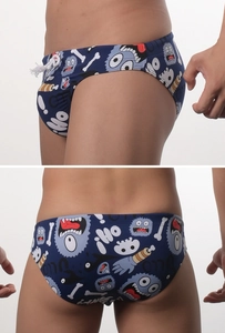 Detail of men's cartoon swim briefs featuring funny monster patterns and white drawstring