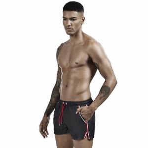 Close-up of men's quick-dry sports shorts featuring red drawstrings and side stripe detail