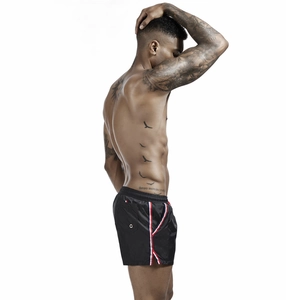 Detailed side view of men's black swim trunks with red and white athletic stripes