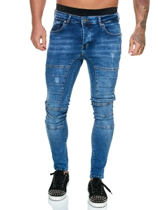 Détails de ce jean moto skinny bleu avec plis accordéon et finitions déchirées délavées
