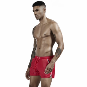 Close-up of red men's sports shorts showing elastic waistband and tricolor tape detail