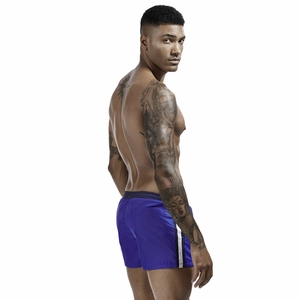 Detail view of royal blue athletic shorts with side stripes and elastic waistband