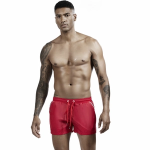 Detail of red men's athletic swimming shorts with drawstring waist and white side stripes