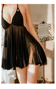 Detail view of sheer black lace nightgown with plunging V-neck and ruffled mesh hemline