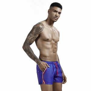 Detail of royal blue running shorts featuring elastic waistband and red contrast drawstring