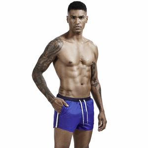Detail of royal blue quick-dry athletic shorts with white drawstring and side stripes