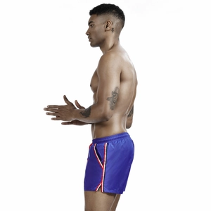 Detail of blue men's athletic shorts with tricolor side stripes and elastic drawstring