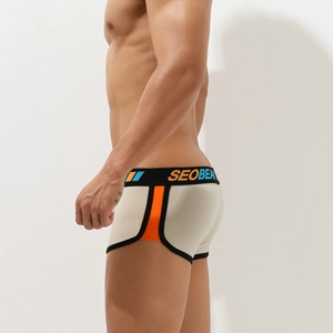 Side view of men's beige boxer briefs with orange contrast panels and elastic waistband