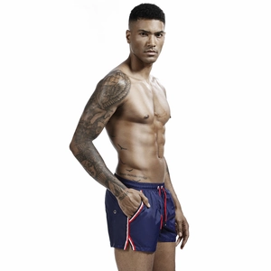 Detail of men's navy blue athletic shorts with drawstring waist and side stripe accents