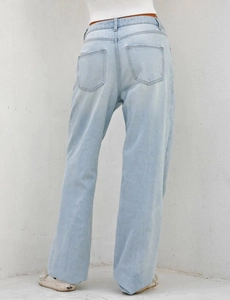 Detail view of high waisted wide leg jeans with light blue wash and back pocket design