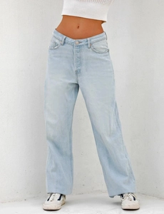 Detailed view of high-waisted wide-leg jeans with washed denim texture and classic pockets