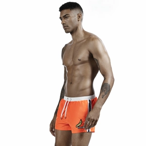 Men's bright orange swimming shorts with banana patch and white drawstring detail