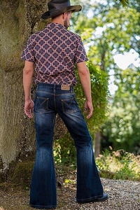 Detail of vintage flare jeans with distinct cat-whisker washing and Y-shaped pocket stitching