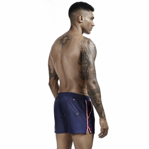 Rear view of navy blue swim trunks featuring side stripes and a functional back pocket