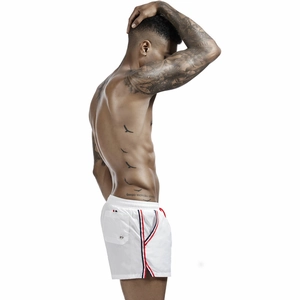 Detail of white men's swim trunks featuring side stripes and elastic drawstring waist