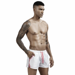 Detail of men's white swim trunks showing the red drawstring and side striped webbing