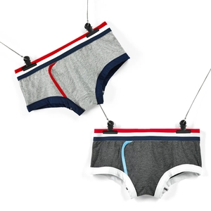 Detailed view of grey men's cotton briefs with striped elastic waistbands on white background