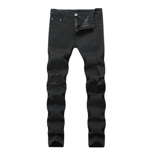 Detailed view of frayed holes and distressed texture on black denim skinny jeans