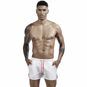 Detail of white men's sports swim shorts with elastic waist and red adjustable drawstring
