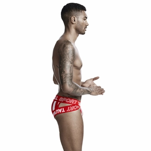 Side view of red athletic jockstrap with white stripes and elastic branded waistband