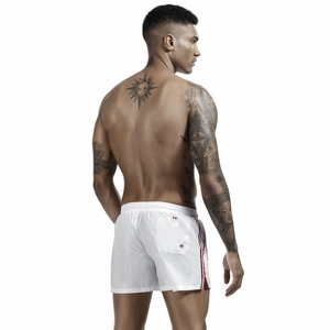 Detail of white quick-dry shorts featuring red, white, and blue side stripes and back pocket