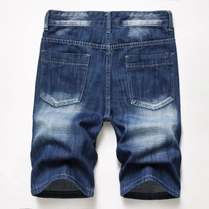 Detail view of vintage dark blue denim shorts back pockets with washed effect