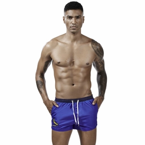 Men's bright blue athletic swim shorts with white drawstring and banana print graphic