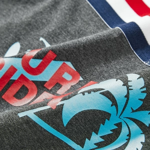 Detail of grey knit fabric with Surf Ride print and navy tricolor ribbon trim