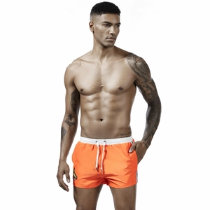 Bright orange quick-dry men's athletic shorts with white drawstring and side stripe