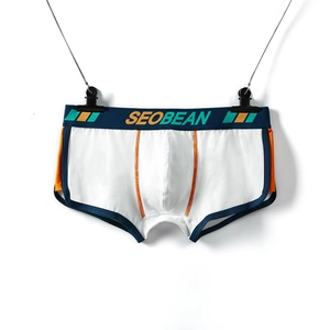 Detail of men's white boxer briefs with contrast orange stitching and navy elastic waistband