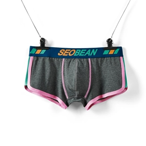 Detail of men's low-waist boxer shorts with contrast stitching and branded waistband