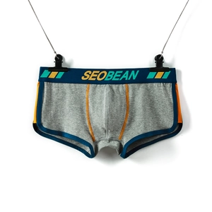 Detail of grey men boxer briefs with blue contrast trim and ergonomic U-convex pouch design