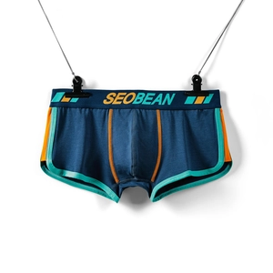 Detail view of navy men's boxers featuring orange and mint green contrast side panels